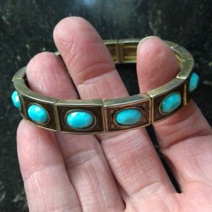 Gold Toned Stretch Bracelet with Blue Gems.